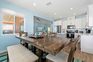 Enjoy casual dining at this kitchen and dining area with a coffee maker, toaster, and stainless steel appliances.
