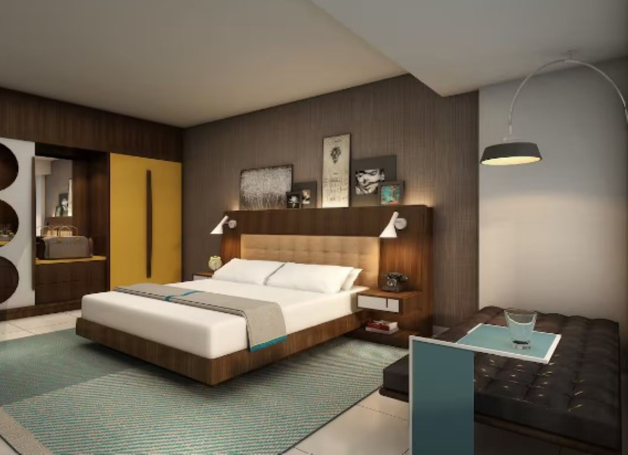 Un dormitorio moderno con una cama grande, mesitas de noche, un armario y un sofá.