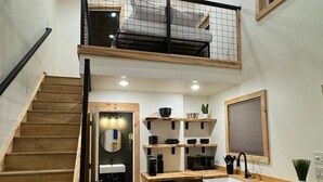 A modern kitchen with wooden cabinets, a built-in dishwasher, and a small island with a sink. - Tiny Cabin, #1 Lamb Point View @ The Cedars (Kanab)