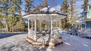 A gazebo with a wooden floor, surrounded by snow-covered ground and trees. - Cloudcroft Vacation Rental ~ 4 Mi to Skiing! (Cloudcroft)