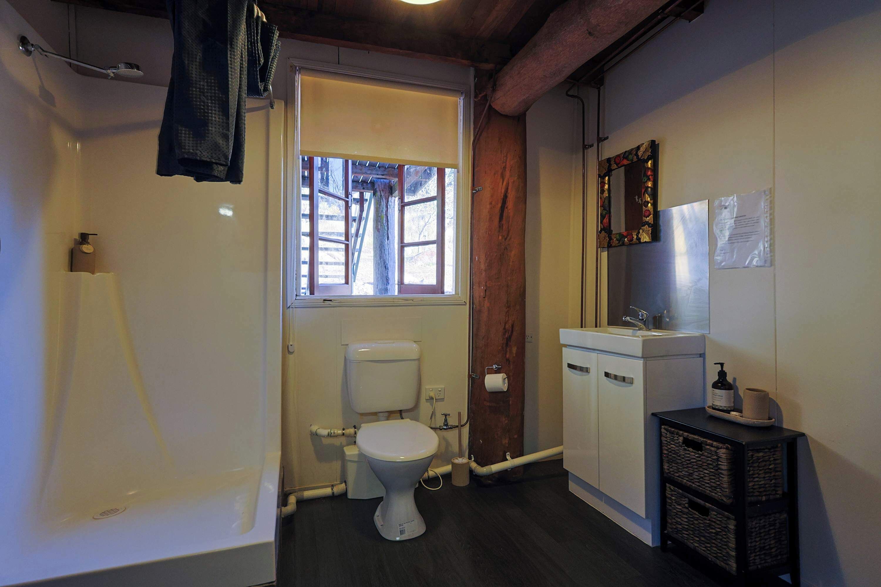 A bathroom with a toilet, sink, and shower.