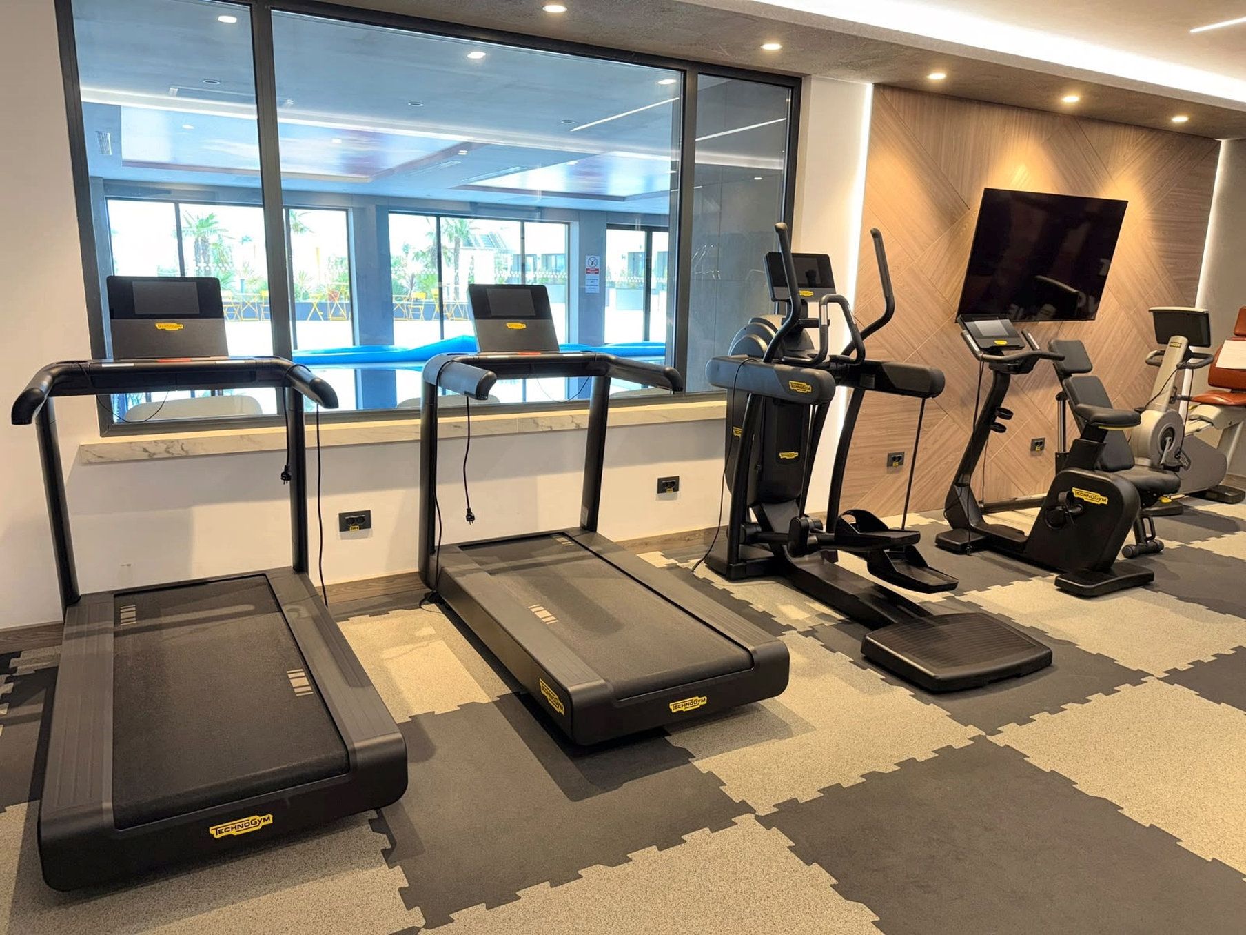 A fitness area with treadmills and elliptical machines.