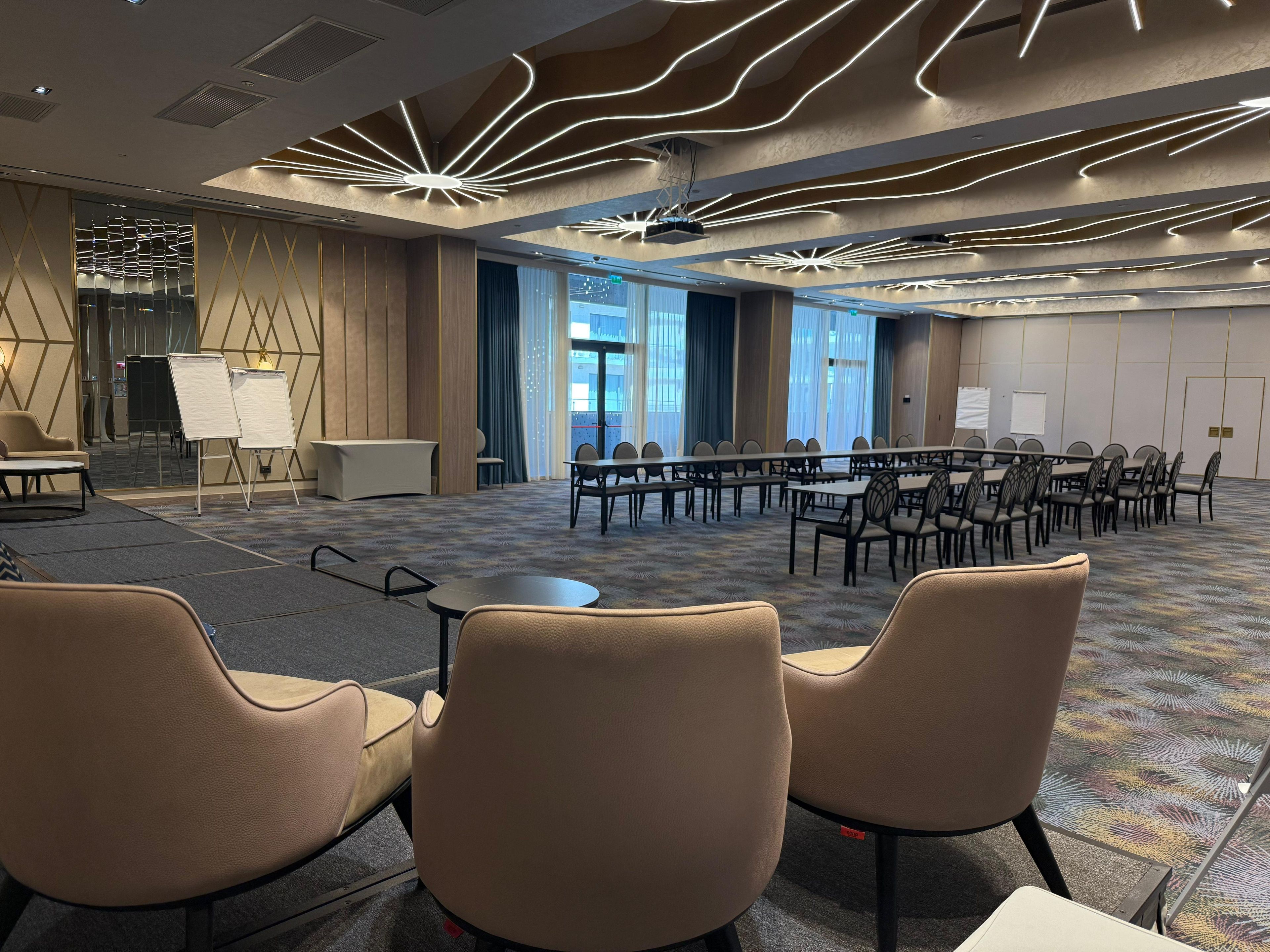 A conference room with a long table, multiple chairs, and a whiteboard.