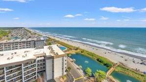 A hotel with multiple floors, a swimming pool, and a beach view. - Unique Beachside Studio at Myrtle Beach Resort (Myrtle Beach)