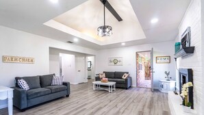 A modern living room with a grey sofa, a white coffee table, and a fireplace. - Stylish, Spacious Entire Hm 4/2 in nice Killeen neighborhood (Killeen)