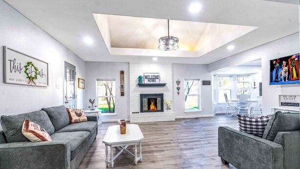 A spacious living room with a fireplace, grey sofas, and a white coffee table. - Stylish, Spacious Entire Hm 4/2 in nice Killeen neighborhood (Killeen)