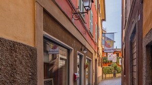 A narrow cobblestone street with buildings on either side. - Blue Diamond by Interhome (Bellano)
