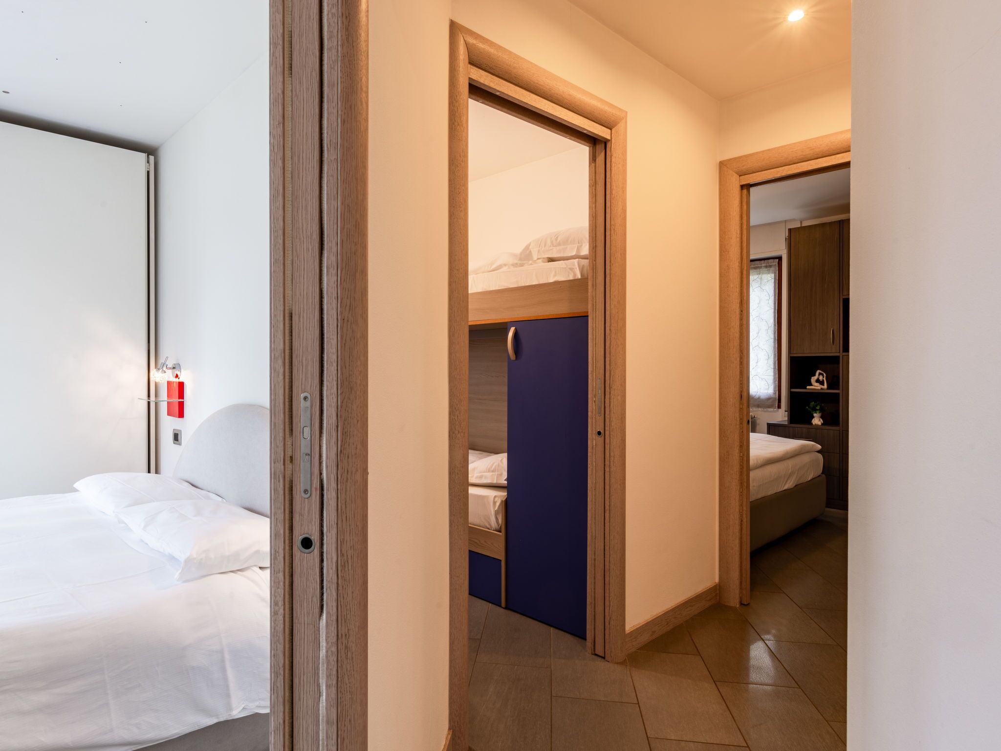 A hotel room with a bed, a wardrobe, and a bathroom.