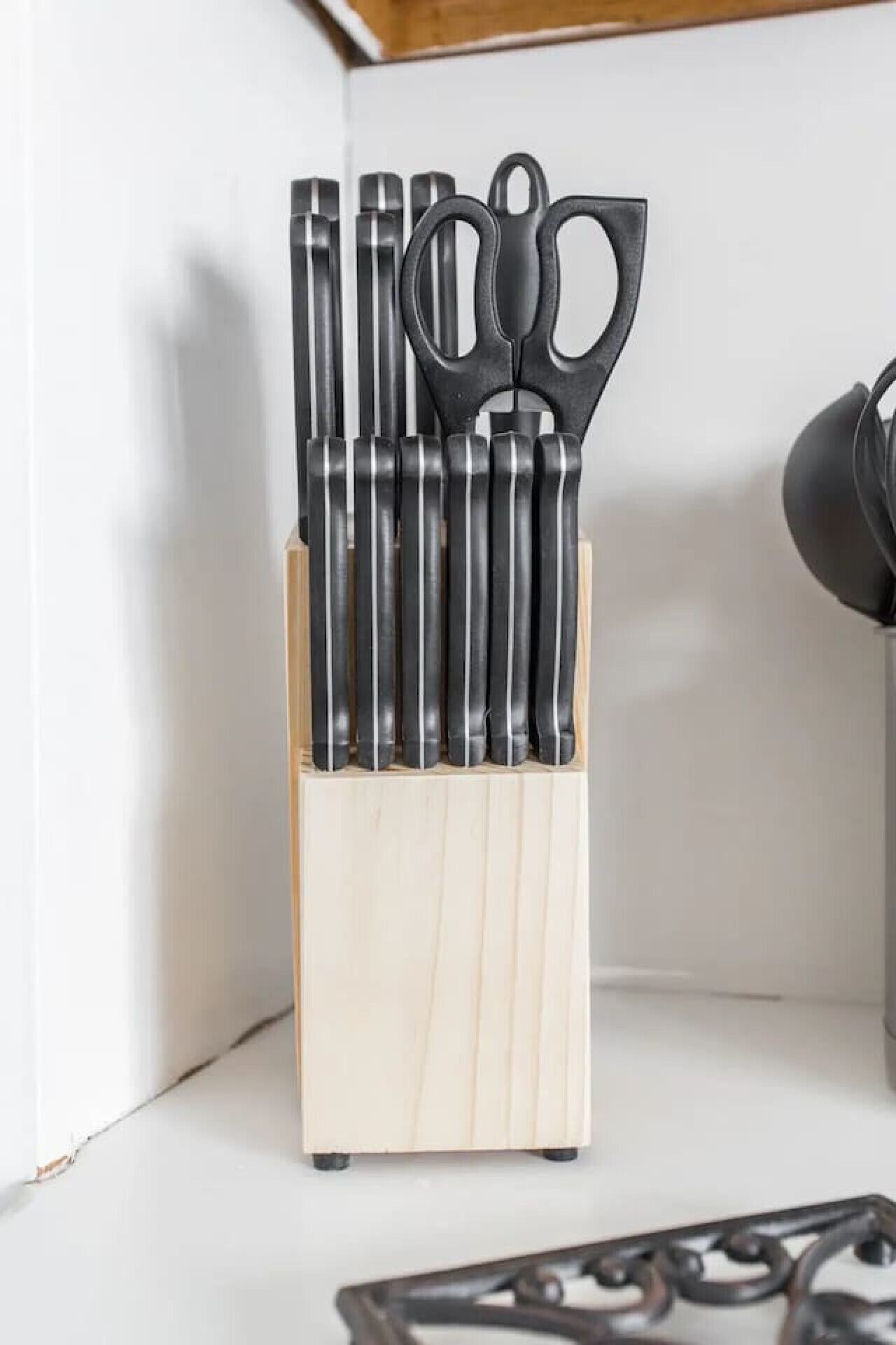 A wooden utensil holder with various kitchen tools.