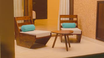 Relax in this serene outdoor seating area with a small pool and comfortable chairs.