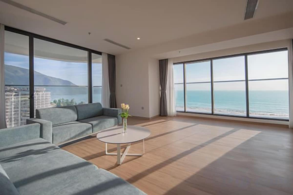 A spacious living room with a large window, a sofa, and a coffee table.