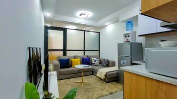 Business Apartment | Living area | 24-inch Smart TV with satellite channels
