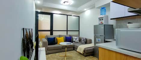 Business Apartment | Living area | 24-inch Smart TV with satellite channels