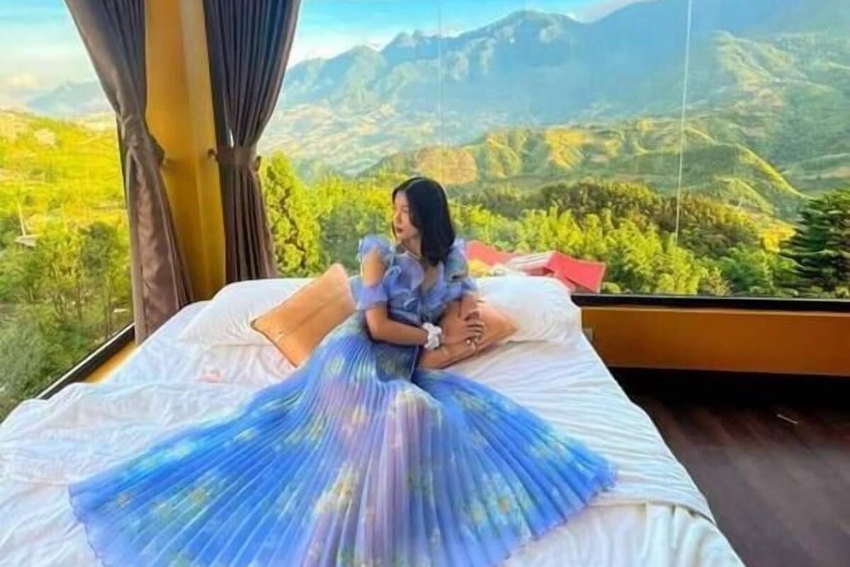 A room with a large window offering a mountain view.