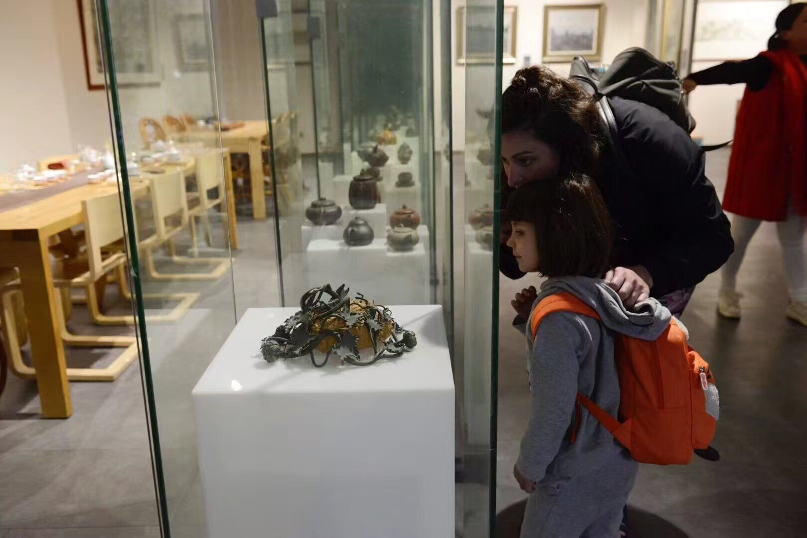 A museum interior with glass display cases containing various artifacts.