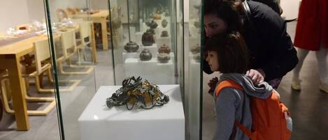 A museum interior with glass display cases containing various artifacts.