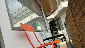 A modern outdoor seating area with a wooden ceiling and a large window. - Hongdae Private Guesthouse (Seoul)