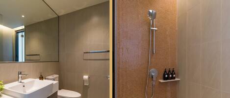 A modern bathroom with a sink, toilet, and shower.