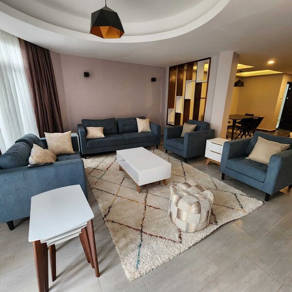 Family Apartment | Living area | 24-inch Smart TV with satellite channels - Lux Suites Westlands Cottage Apartments (Nairobi)