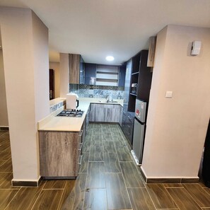 Family Apartment | Private kitchen | Fridge, microwave, cookware/dishes/utensils - Lux Suites Westlands Cottage Apartments (Nairobi)