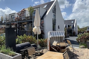Enjoy al fresco dining on the deck with a barbecue grill and seating area.
