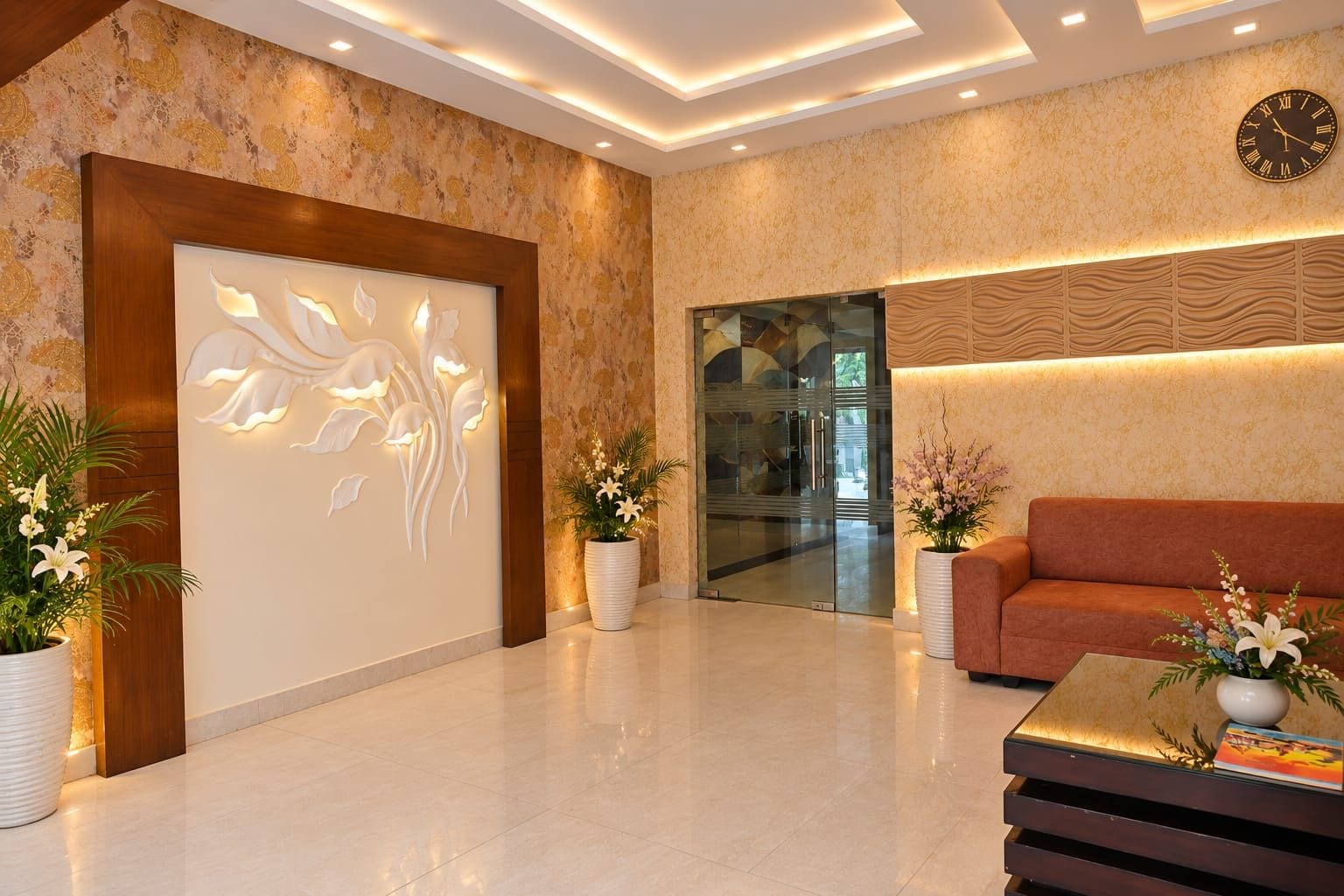 A modern lobby with a reception desk, a sofa, and decorative plants.