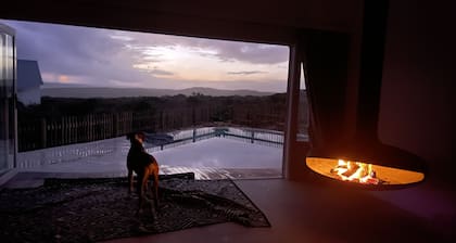Tranquil haven: home in nature's embrace, where ocean and dunes unite.