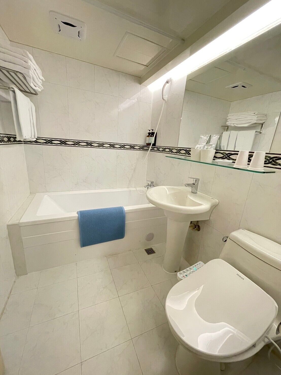 A bathroom with a bathtub, sink, and toilet.