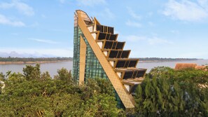 A modern building with a unique triangular design, large windows, and solar panels. - NAKA-RAJ Escape Hotel (Nakhon Phanom)