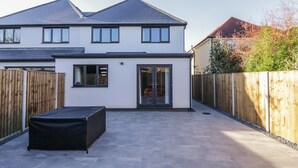 A two-story house with a patio area.
