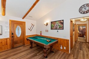 A pool table in a room with wooden walls and a wooden ceiling. - Located in the Castle Glen Estates! Recently Remodeled Master! Pet Friendly! Pool Table! Foosball! (Big Bear Lake)