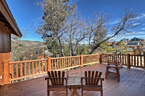 A wooden deck with Adirondack chairs and a railing overlooking a mountainous landscape. - Located in the Castle Glen Estates! Recently Remodeled Master! Pet Friendly! Pool Table! Foosball! (Big Bear Lake)