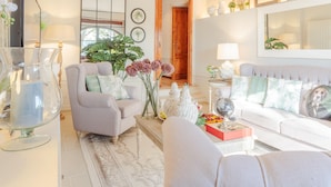 A living room with a sofa, armchairs, a coffee table, and decorative items. - Amore Farmhouse Retreat (Lucca)