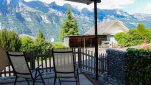 A patio with two chairs overlooking a mountainous landscape. - The Mountains are Calling Retreat (Quarten)