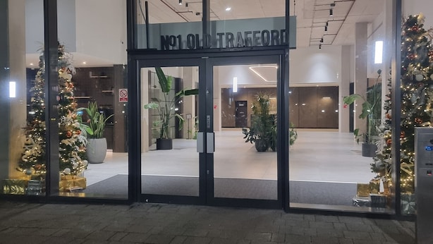 The entrance to a building with a sign reading "No1 Old Trafford". - Captivating 1-bed Apartment in Manchester (Manchester)