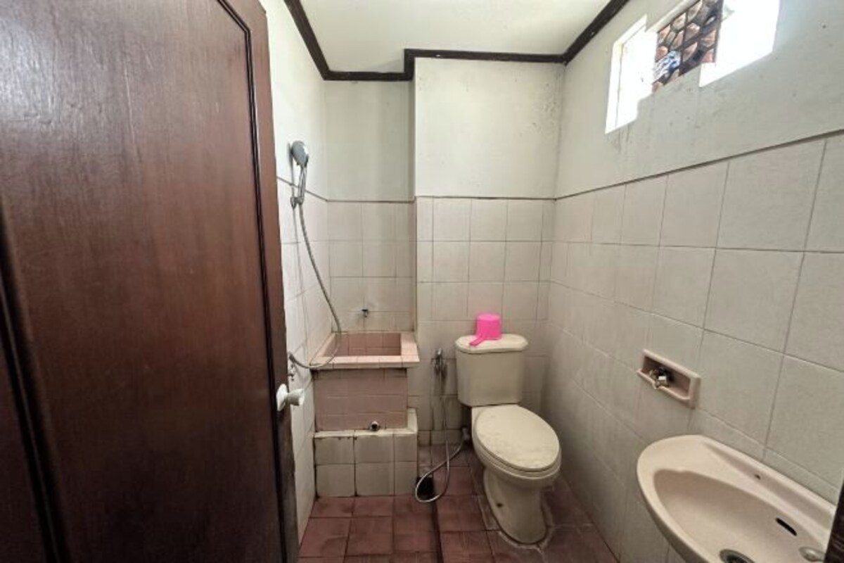 A small bathroom with a toilet, sink, and bidet.