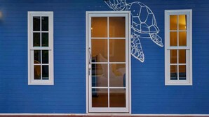 A building with a blue exterior, a white door, and two windows. - Bluvilla Sattahip (Sattahip)
