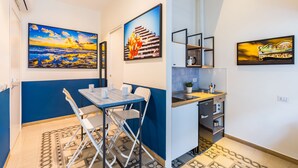 A compact kitchen with a sink, countertop, and storage cabinets. - Central Station Apartments & Suites by Wonderful Italy (Naples)