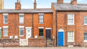 A row of terraced houses with brick facades, white window frames, and a variety of door colors. - Little Braybrooke Cottage- Saffron Walden (Saffron Walden)