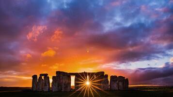 Stonehenge with a sunset in the background.