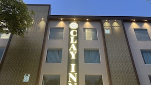 A hotel facade with a sign reading "Clay Inn" and "Rooms & Celebrations". - Clay Inn Hotel Gurugram (Gurugram)