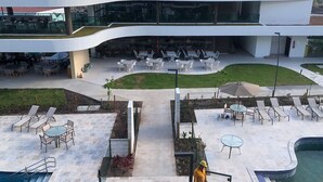 A modern building with outdoor seating areas, a pool, and a landscaped garden. - Makia Beach Resort Experience By All (Ipojuca)