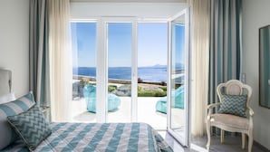 A bedroom with a bed, a chair, and a view of the sea through a sliding glass door. - Villa Monte Leone by Konnect with Pool, Hot Tub, Spa Room & Stunning Seaview (Corfu)