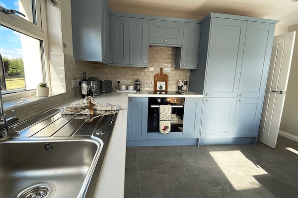 Spacious kitchen with all modern appliances and dining table