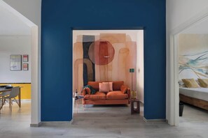A modern living room with a blue accent wall, a sofa, and a coffee table.