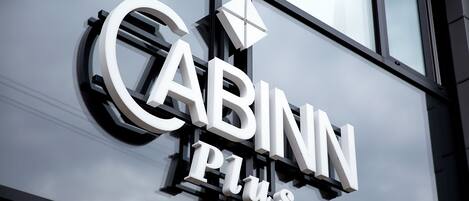 A building with a sign that reads "CABINN Plus".