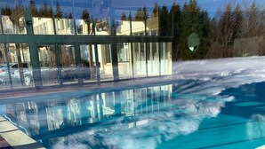 A swimming pool with clear water and a tiled deck.