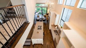 A modern interior with a staircase, a dining area, and a kitchen.