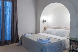 A bedroom with a bed, a nightstand, a lamp, and a window with curtains. - Elegant Farmhouse With Swimming Pool - Beahost (Galatina)
