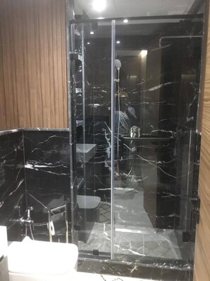 Shower, hair dryer, towels, toilet paper